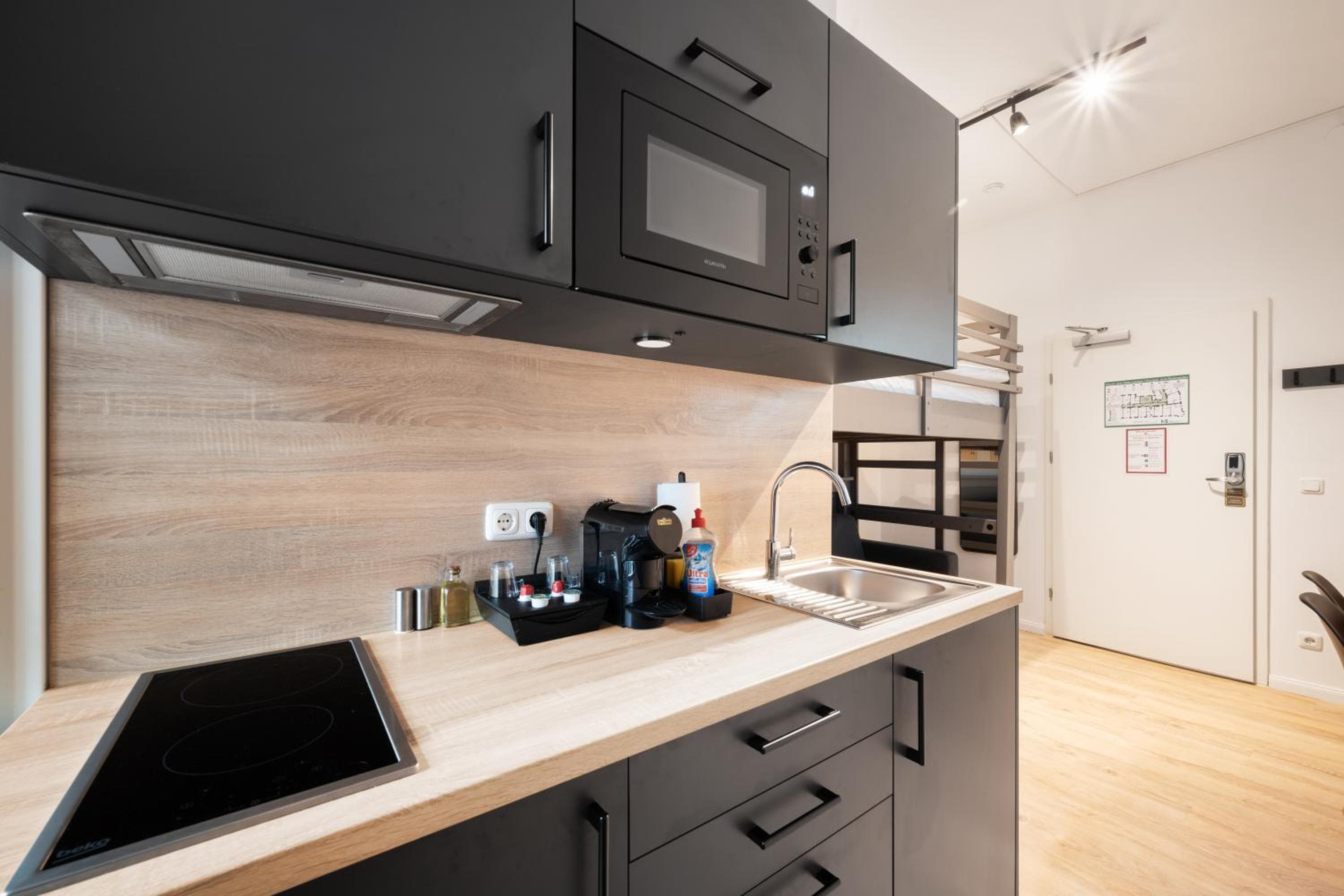 Kitchen at Servus Apartments by Homaris